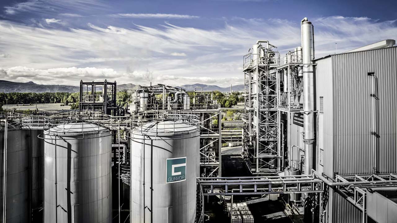 Photo of an industrial complex with tanks and pipes, including Gunvor's logo.